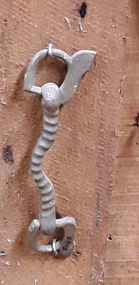 A decorative ribbed brass horse bit or mullen which is part of a horse's tack.