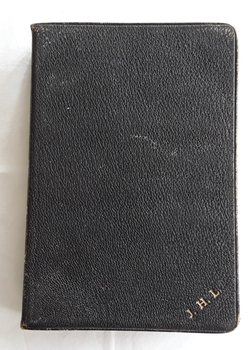 A black leatherette softcover Holy Bible contains the Old and New Testaments and a prayer book