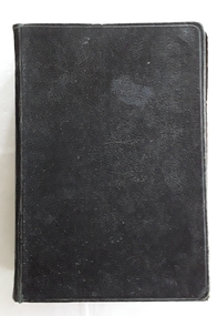 A black hardcover Holy Bible - Revised Version