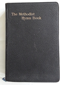 A black speckled self textured covered Methodist Hymn Book with tunes. 