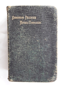 A faded badly damaged black miniature leatherette softcover book, The Book of Common Prayer Hymnal Companion.