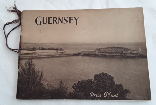 A slim rectangular brown toned softcover booklet with Guernsey printed in black lettering at the top of the front cover.