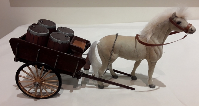A model of a Small Wheel Lorry with a brown short wooden tray with low sides drawn by a cream horse.
