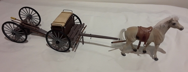 Three wooden model military gun carriages and equipment: two with horses.