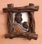 Two hand carved Indigenous busts in wood frames: a mother and child and a father and child.
