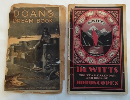 Two old booklets about ailments that people suffer with the title Doan's Dream Book and De Witt's 200 Year Calendar.