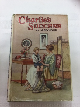 A hardcover book with a colourful paper dust jacket of a mother and boy.
