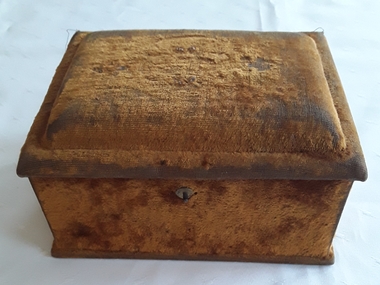 A tan velvet lidded sewing box with brown satin on the inside of the lid.