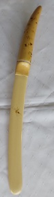A highly polished cream coloured long vintage celluloid page turner used for reading.