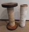 Two vintage or antique wooden and thick cardboard industrial large sewing spools.