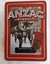 A large rectangular Limited Edition red lidded Anzac Biscuit Tin with an embossed old brown toned photograph image of a soldier on parade. 