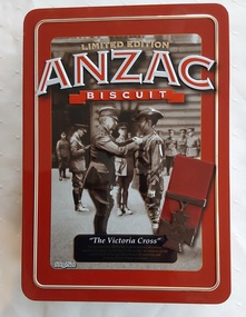 A large rectangular Limited Edition red lidded Anzac Biscuit Tin with an embossed old brown toned photograph image of a soldier on parade. 
