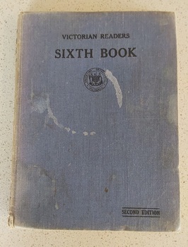 A faded blue fabric covered hardcover with the title Victorian Reader Sixth Book, Second Edition