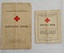 Two copies of Australian Red Cross Society Knitting Book, one small (red cover)and one larger (white).