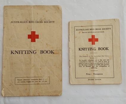 Two copies of Australian Red Cross Society Knitting Book, one small (red cover)and one larger (white).