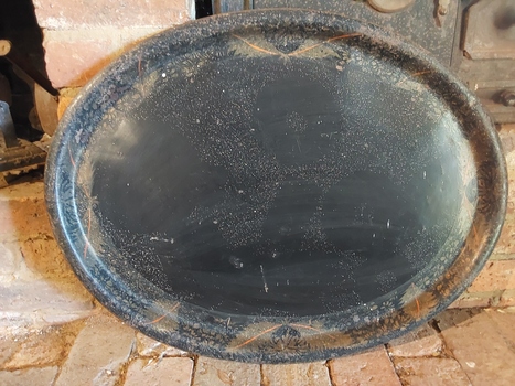 A very large vintage Japan black metal oval tray with a faded golden coloured leaf pattern. 