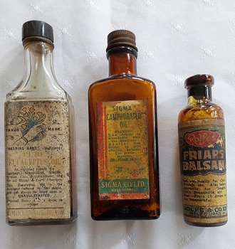 Four glass medicinal bottles: Eucalyptus Oil, Camphorated Oil, Friars Balsam, Eucalyptus Oil