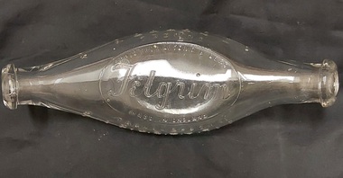 A clear glass Felgrim Banana bottle (valve and teat) for feeding babies by hand.