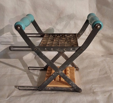 A vintage manual metal and plastic Chipper and French Fry Cutter with two blue turned wooden handles each side.