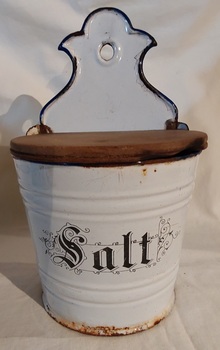 An early 20th century white wall mount enamel tin wall Salt Box with a wooden lid. 