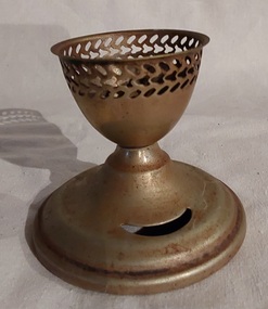 A vintage silverplated egg cup with decorative three lines of a cut out trim near the rim at the top. 