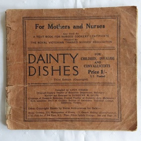 A slim brown badly damaged paperback book with the title, Dainty Dishes for Children, Invalids and Convalescents.