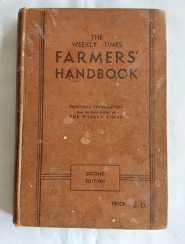 A brown hardcover book with the title printed in black text, The Weekly Times Farmers' Handbook on the front cover.