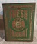 A large square rusty metallic silver surface green coloured Glen Valley Tea storage tin with a lift off lid.