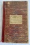 A large red, blue and cream wavy lined paper patterned covered Norman Bros., Minute Book with burgundy tape on the spine.