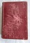 A damaged vintage red covered fiction book, The Virginians by W M. Thackeray.