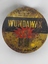 A flat round vintage Wundawax Floor Polish tin with a removable lid and polish contents inside.