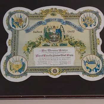 A scalloped shaped framed certificate presented to Reginald J. Sebire in July 1914.