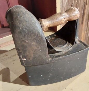 A rare cast iron charcoal clothes iron with a wooden handle, complete with a funnel and chimney. 