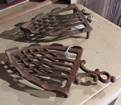 Two vintage decorative cast iron trivets for vintage flat irons. 