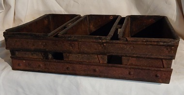 This is an antique, bread baking tray. There are three tins joined by rivets to a heavy metal frame, so they cannot be separated.