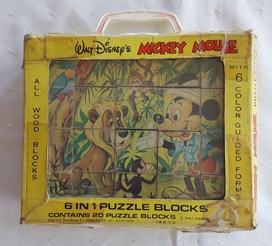 20 piece Walt Disney's All Wood Blocks puzzle with 6 coloured forms or pictures on all four sides of the blocks in a yellow cardboard carry case.