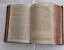 An olive green hardcover Holy Bible, Authorized Version of the New and Old Testaments with a wide brown band at the edge next to the spine and triangular corners on the right edges.