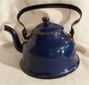 A small dark blue enamel hot water kettle with a black curved moveable handle riveted onto the top sides and a goose neck spout.