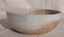 A small white crazed glazed pottery bowl used in the kitchen.