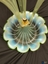 Green and blue clouded glass fruit bowl with scalloped edges, comes upwards at middle to hold four flutes on a gold star