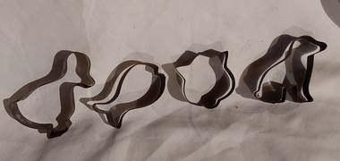 Four animal shaped vintage tin biscuit or pastry cutters - a cat, dog, fish and duck. 
