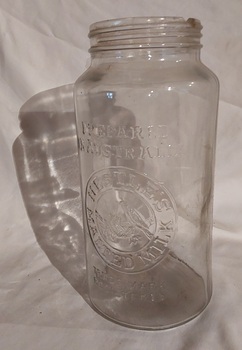 A tall clear Nestle's Malted Milk glass jar, with no screw on lid.