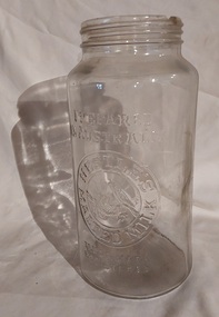 A tall clear Nestle's Malted Milk glass jar, with no screw on lid.