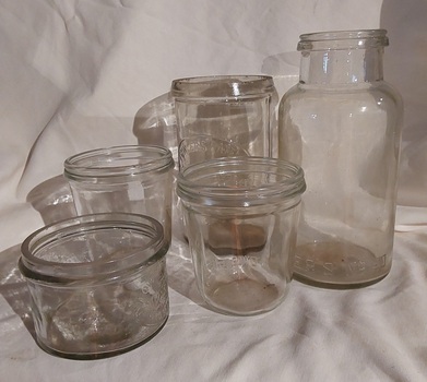 Five mixed Fowler's clear glass preserving or storage jars with no lids.