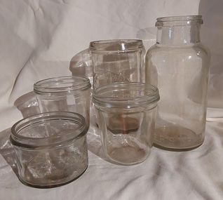 Five mixed Fowler's clear glass preserving or storage jars with no lids.