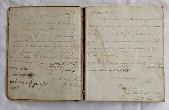 A green marbled paper covered hardcover school homework book which belonged to Ms Beryl Jacquier. 