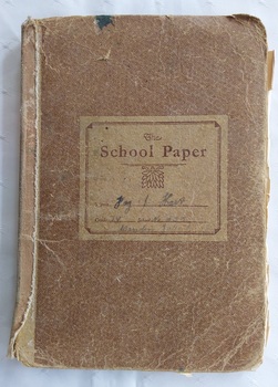 11 paper children's monthly magazines held by string inside a faded brown cardboard The School Paper cover.