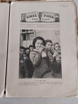 11 paper children's monthly magazines held by string inside a faded brown cardboard The School Paper cover.