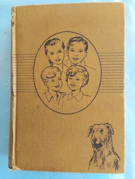 A tan coloured hardcover book, The Bobbsey Twins at School by Laura Lee Hope. 