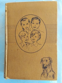 A tan coloured hardcover book, The Bobbsey Twins at School by Laura Lee Hope. 